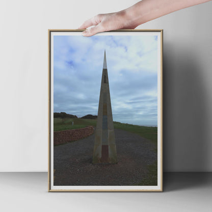 Coastal Obelisk Monument Poster, Stone Spire Landmark Wall Art Print, Dramatic Sky Sculpture Photography, Moody Coastal Landscape Print