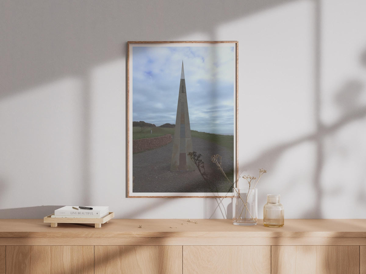 Coastal Obelisk Monument Poster, Stone Spire Landmark Wall Art Print, Dramatic Sky Sculpture Photography, Moody Coastal Landscape Print