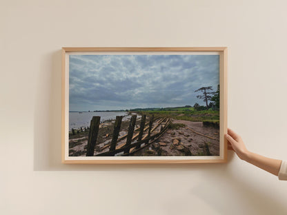 Wooden Boat Wreck Estuary Poster, Moody Coastal Landscape Framed-Print, British Shoreline Wall Art, Rustic Nautical Decor, Cloudy Sky Print