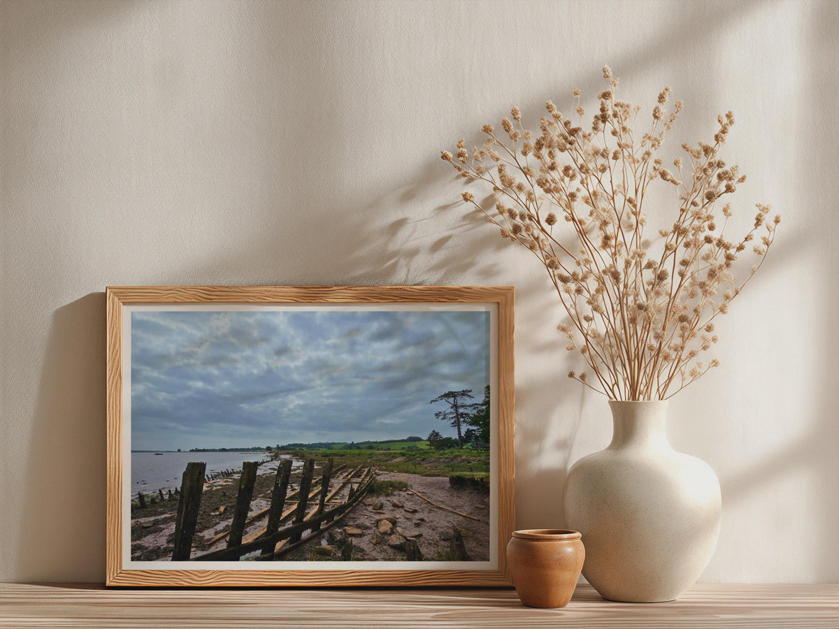 Wooden Boat Wreck Estuary Poster, Moody Coastal Landscape Framed-Print, British Shoreline Wall Art, Rustic Nautical Decor, Cloudy Sky Print